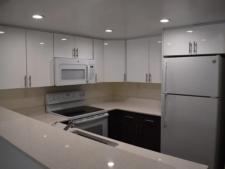 Kitchen with Modern, White Plywood Cabinetry and Self-Closing Hinges