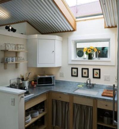 Compact kitchen includes 2-burner cooktop, toaster oven, brand new refrigerator, sink, cookware, plates, glasses & utensils included if desired.