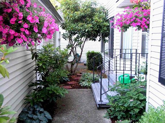 Beautiful private garden entry between your front door and extra-large single car garage.