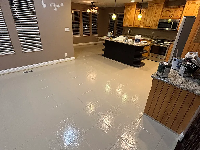 Additional photo of living room with kitchen and dining areas. New epoxy flooring on tile.