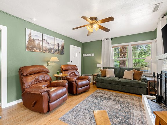 Cozy living space with 55" Smart TV, pull-out sofa, and gas fireplace.