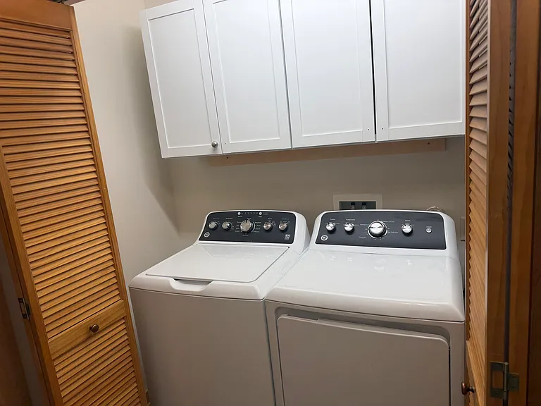 Laundry with new washer and dryer and new cabinets