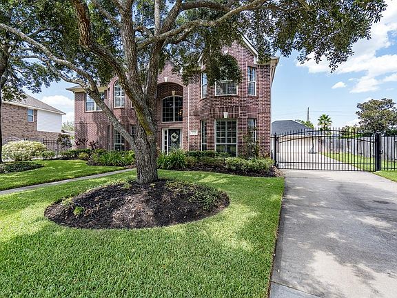 This property features a long driveway that leads to a detached 3-car garage with extra depth, and a iron gate for added security and gives the furry friends extra room to play with views of the front yard!