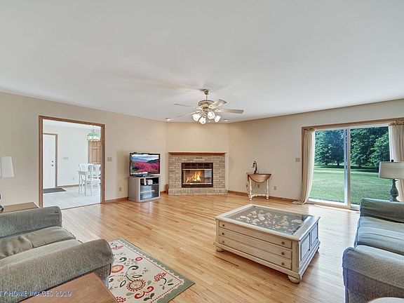 Large living room has refinished Bruce oak hardwood floors, sliding door to back patio, and wood fireplace.