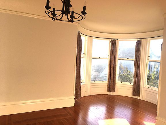 other half of huge room with 2 round bay windows