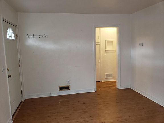 Living room with main entrance and entrance to hall.