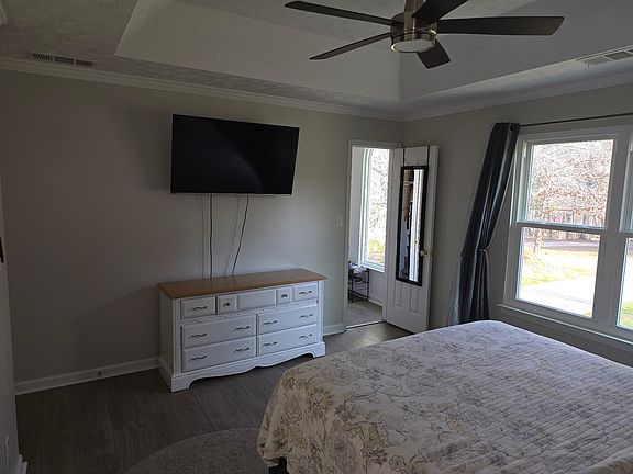 Master bedroom with entrance to walk-in closet