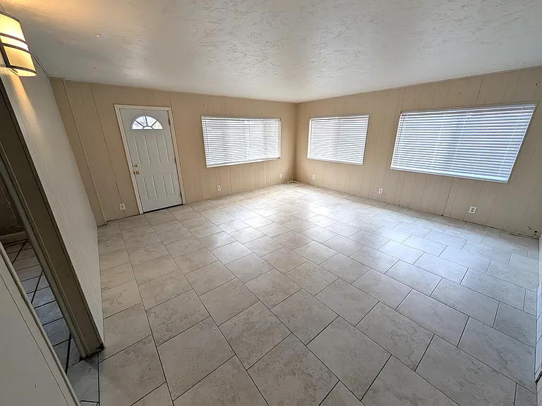 Large. bright living room with porcelain tile floors