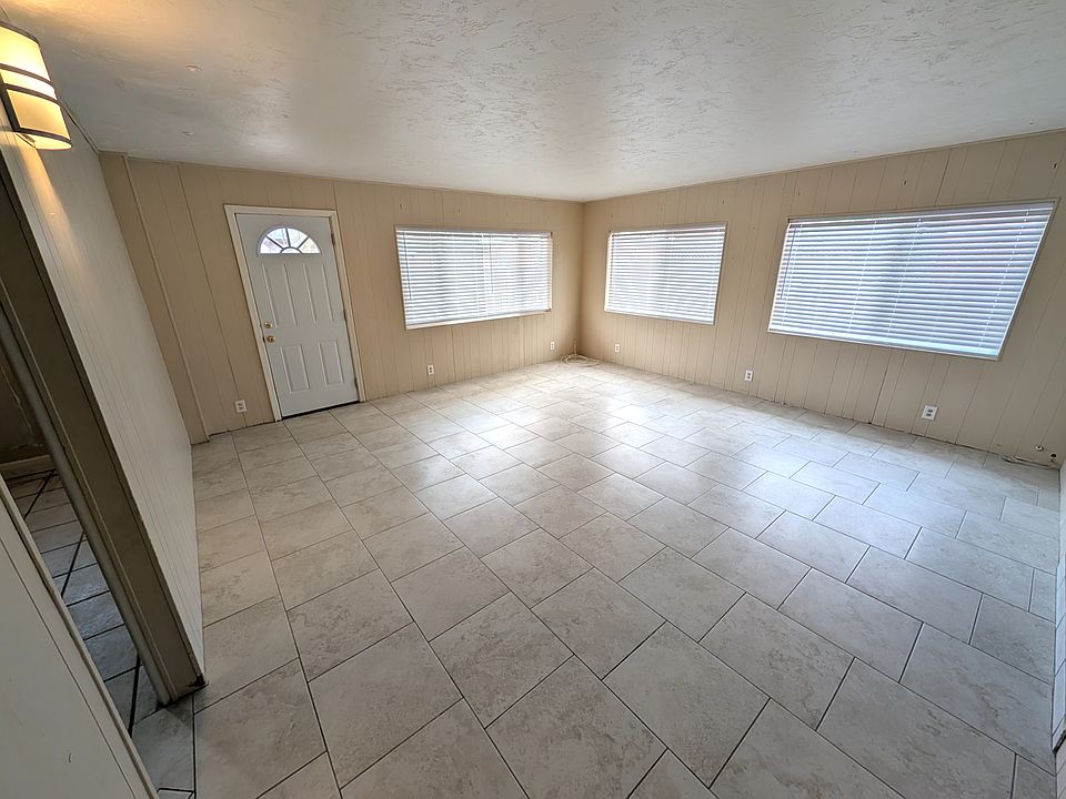 Large. bright living room with porcelain tile floors