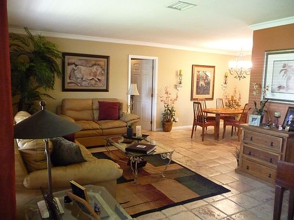 Open living room/dining room with crown molding