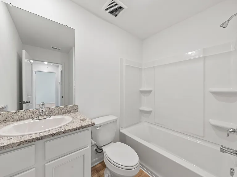 Second bathroom with a shower/tub combination.
