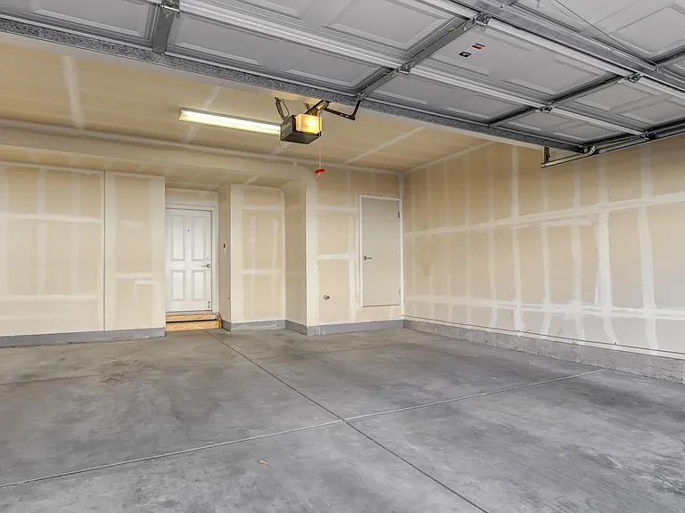 Attached 2.5-car garage with parking and storage space