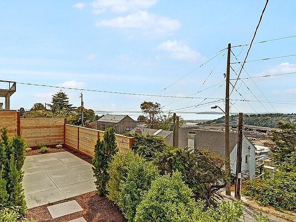 Sunny fenced garden and patio overlooking Puget Sound