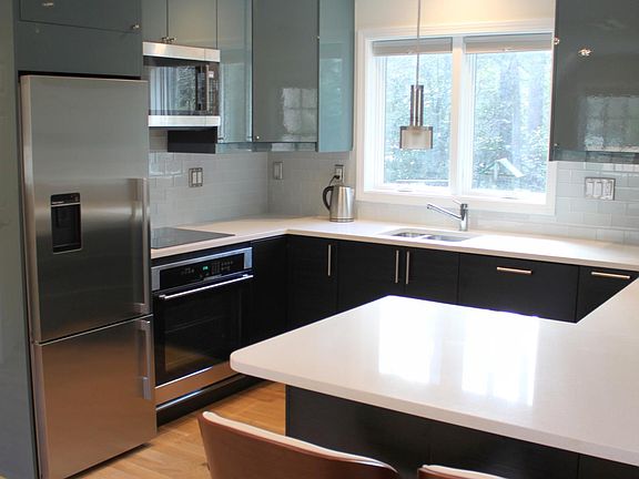 Super modern kitchen with granite surface, water-dispensing fridge-freezer, convection oven, microwave, full-size dishwasher, coffee maker, blender, plus fully equipped utensil drawers + cupboards
