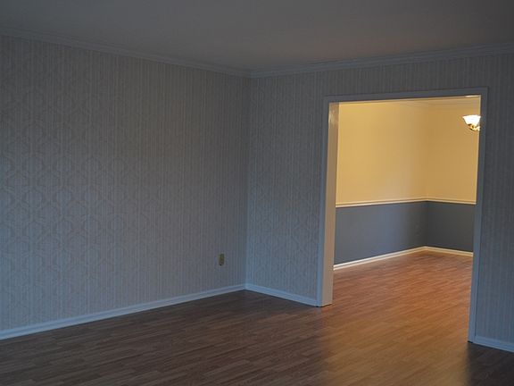 Living Room w/ Wood Laminate Leading into Dining