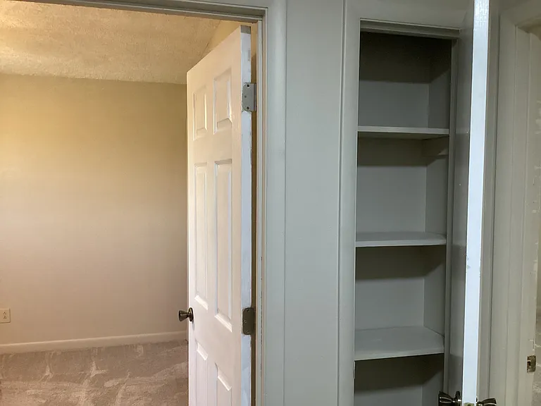 Back bedroom and a closet next to bedroom