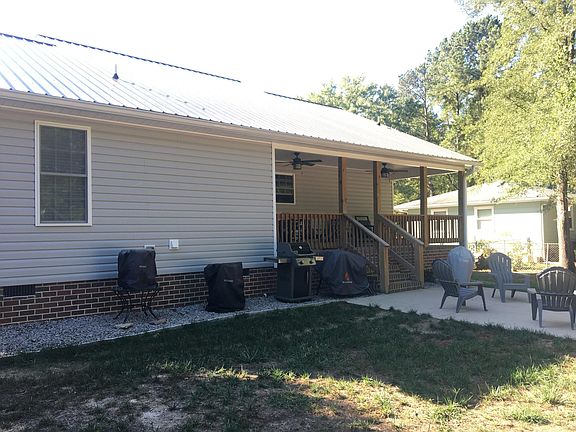 Back of house w/ concrete patio