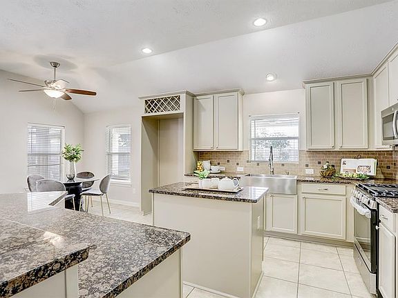 Newly updated kitchen with stainless steel appliances and farmhouse sink.
