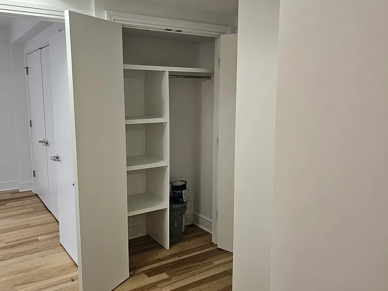 Hallway with view of Bedroom 2 and hallway closet