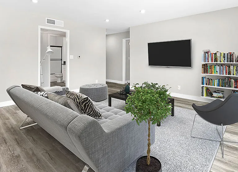 Large hardwood floored living rooms with can lights