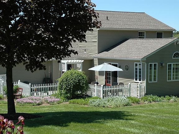 Rear w/patio and Norway Spruce