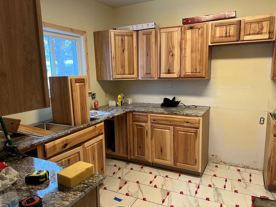 Kitchen in progress, porcelain flooring in being installed, stainless steel Frigidaire appliances to be delivered Monday