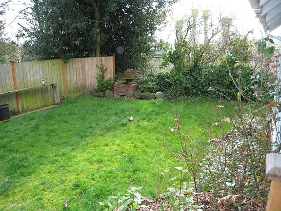 Back yard with fire pit and southerly view. Garage is out of frame on the right.