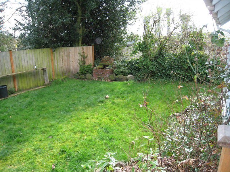 Back yard with fire pit and southerly view. Garage is out of frame on the right.