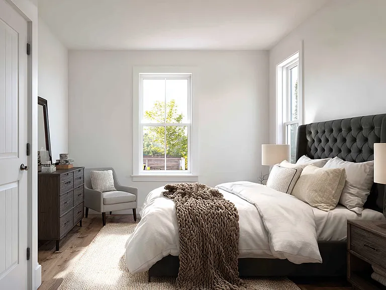 Spacious 13x12 primary bedroom with smooth white walls, warm LVP flooring, double hung windows, and generous closet space. Easily accommodates a queen or king suite.