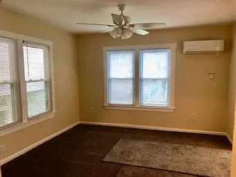 Living/Bedroom area looking to exterior front and exterior right. mini-split HVAC on front wall.