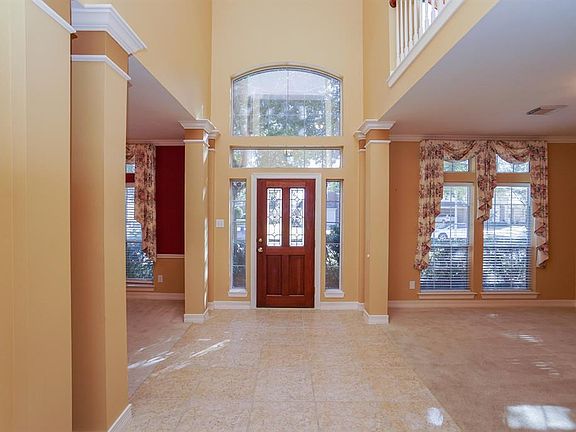 Tile floors welcome you into this home which is accented with raised ceiling and trimmed columns.