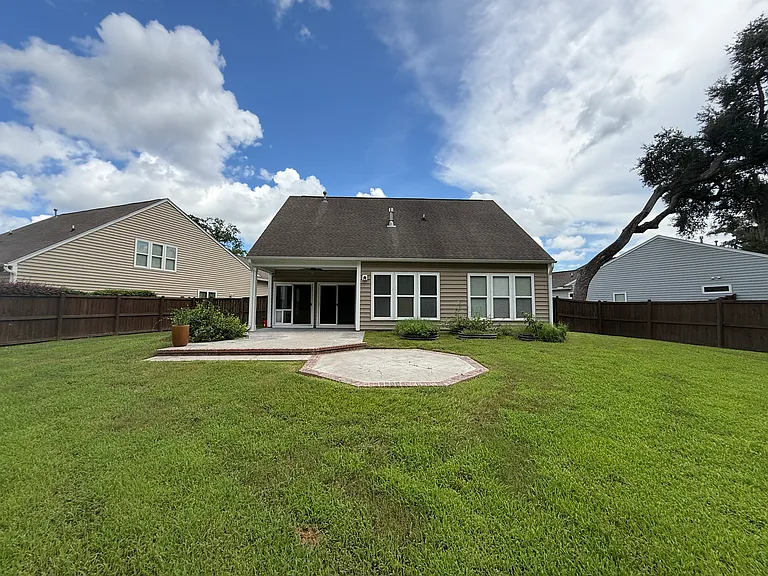 The largest backyard in Carolina Bay!! Fully fenced premium lot featured a covered patio, extended grilling area, and tons of private lawn space.