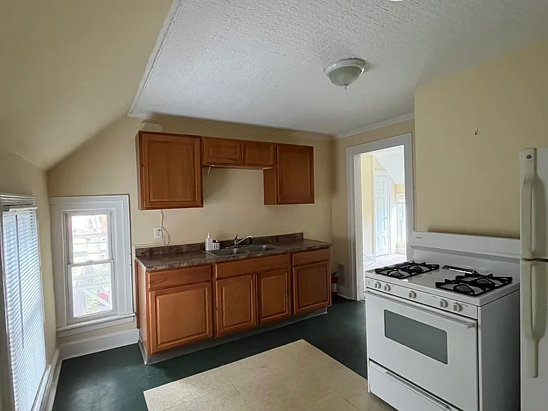 Kitchen with view of entrance to living room.