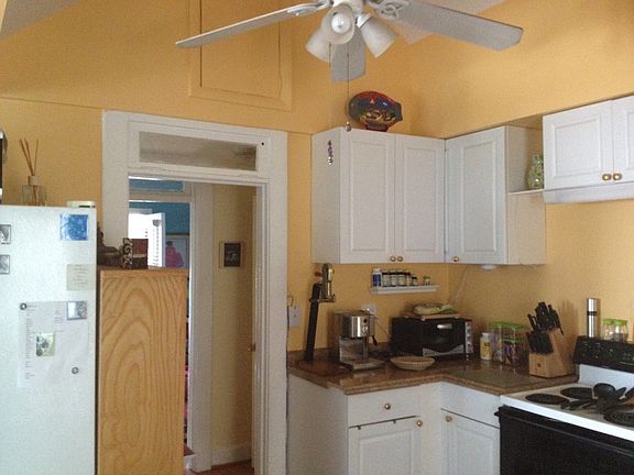 kitchen with vaulted ceilings and fans