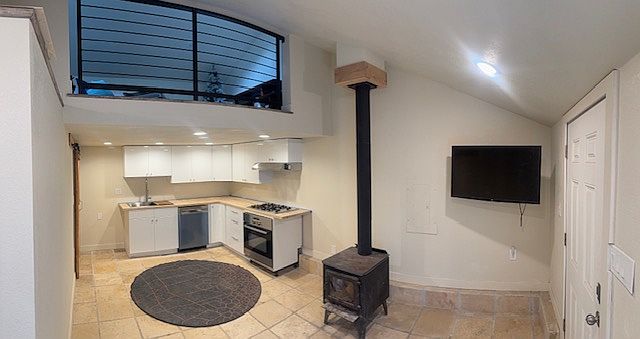 Entry welcomes you with fire-burning stove, SmartTV, brand new kitchen and room for a cozy couch. (Pantry is housed behind the barn door and has a brand new refrigerator and storage shelves).