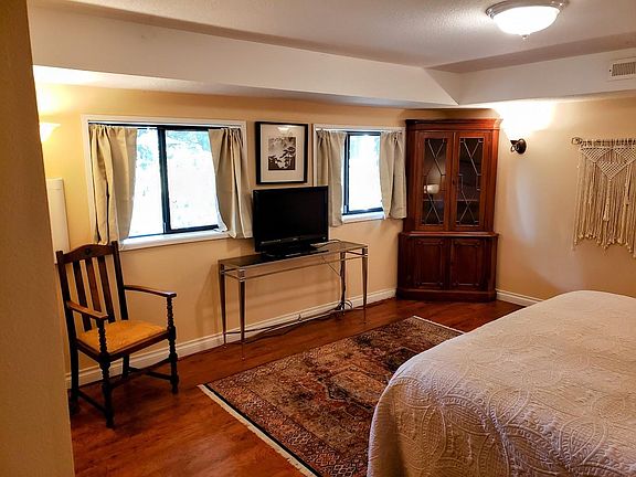 South-facing double-pane window with view of pool and walkways