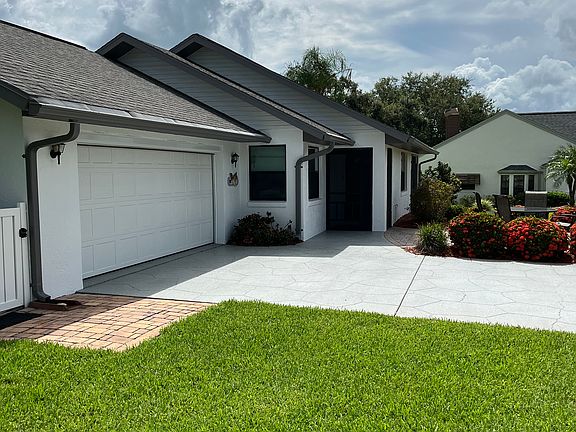 Two car garage WITH motorized vertical screen (not shown) for wonderful full cross breeze through the home.