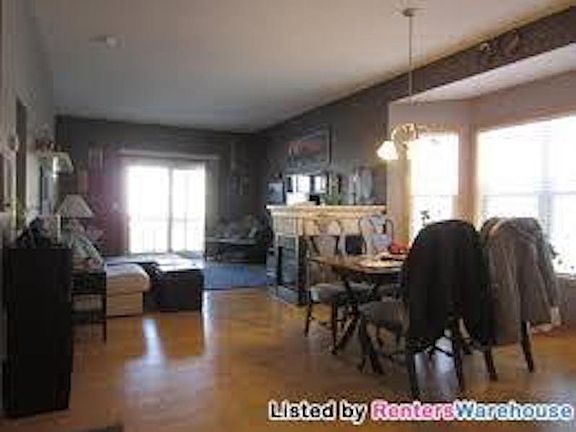 Main living area with 3 sided fireplace, 1/2 bath, patio doo