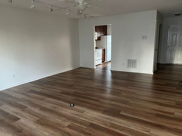 Kitchen viewed from Living Room back door; laundry closet is off hallway near the front door/entrance; note track lighting in LR