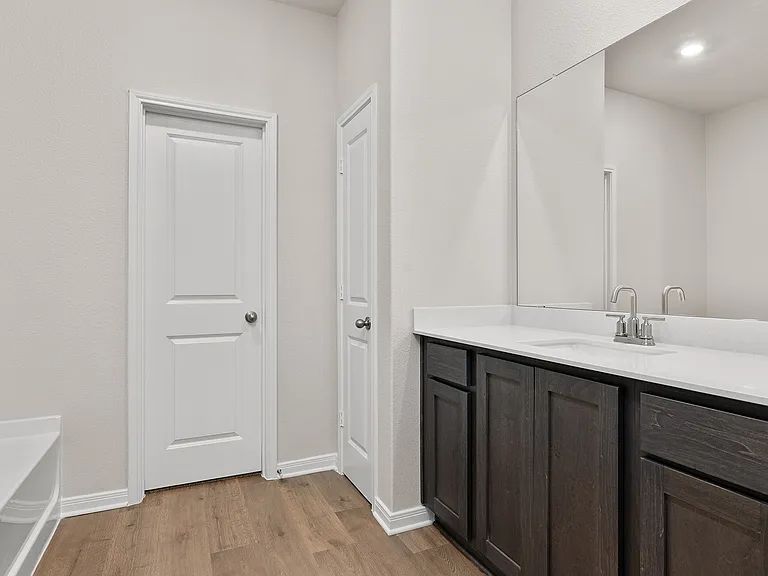 The master bathroom has a sprawling vanity.