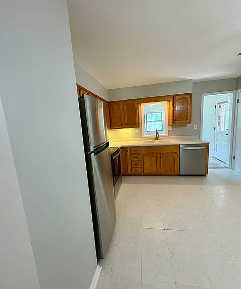 Updated kitchen feature brand new Whirlpool stainless steel appliances and ceramic tile floor.