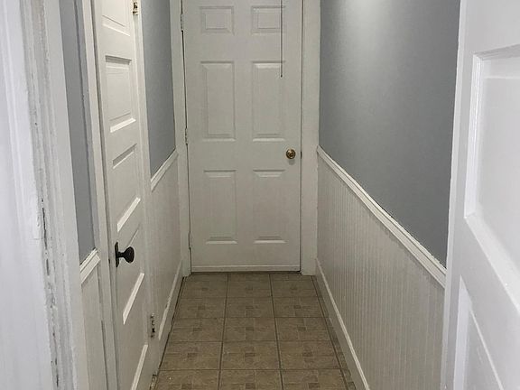 Hallway to the back entrance, storage closet on left