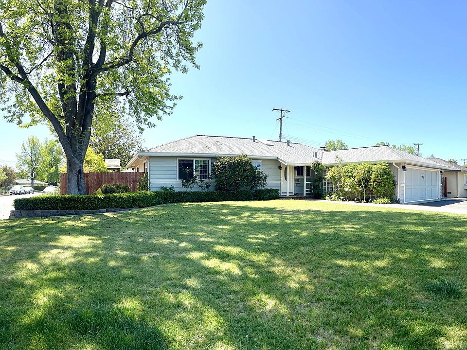 Corner Lot Home with lush green lawn in front and back.
