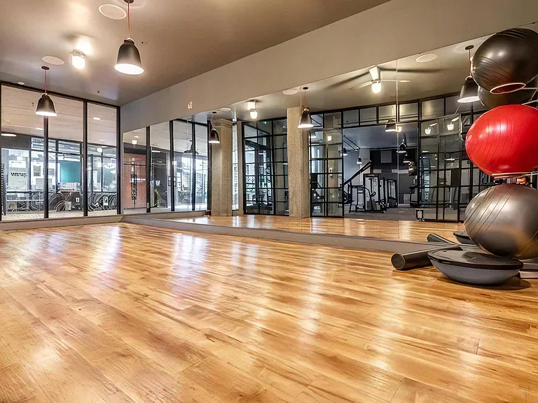 Fitness Studio Featuring Wood Flooring and Yoga Equipment