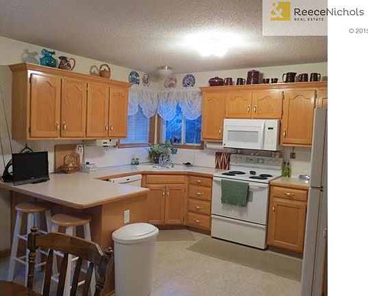 Spacious Kitchen with lots of cabinets, counter space and pantry.  Corner sink overlooks flowering back yard.