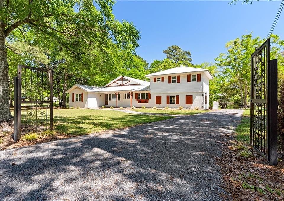 Colonial-style house with a front yard and driveway