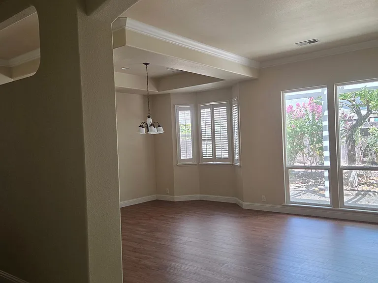 Living room with new wood floors, formal dining room with plantation blinds