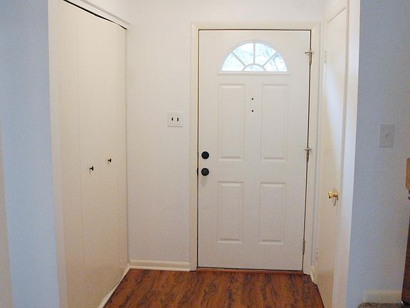 Inside looking towards front door. Closets on left and right inside front door. Opening to kitchen on your left. Steps to 2nd floor on your right.