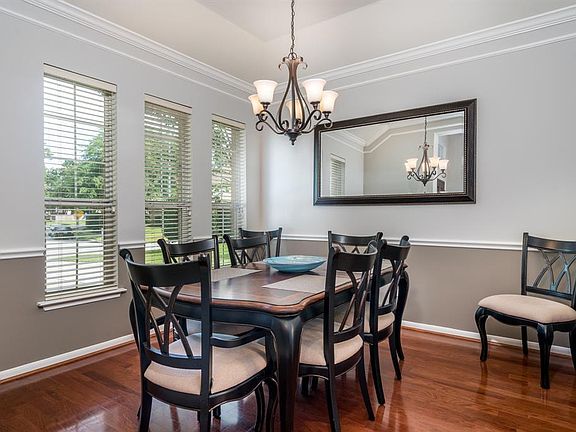 Just of the entry is this fabulous formal dining room complete with crown molding, chair molding, vaulted ceiling and gorgeous hardwood flooring!