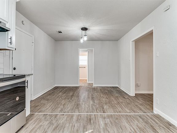 Unfurnished dining area with light wood-style floors and baseboards